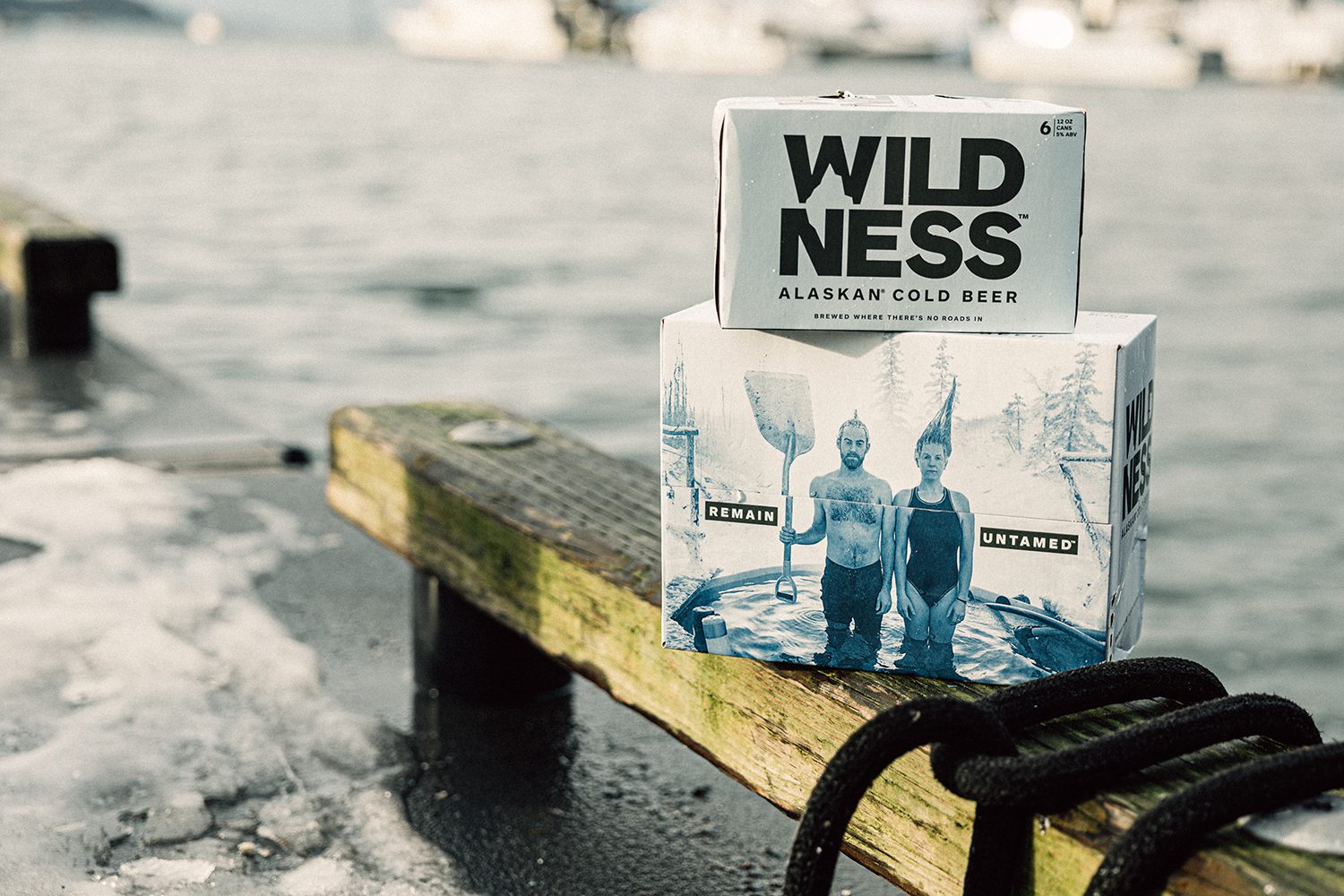 Packages of WILDNESS beer sit on an icy dock